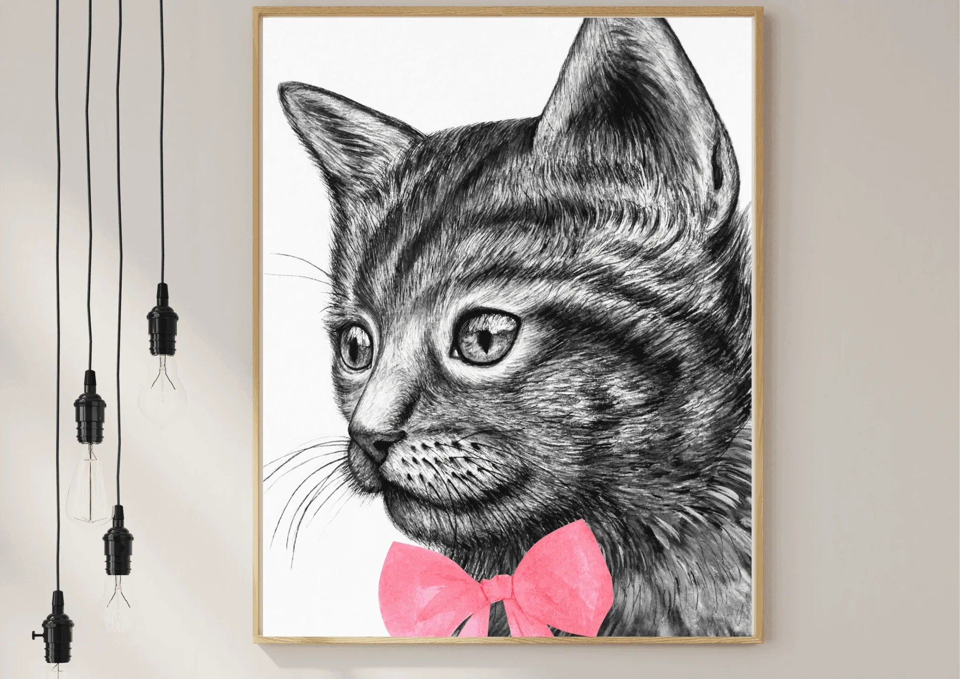 A framed black and white digital art print of a hand-drawn cat with a simple, modern design, hanging on a white wall.