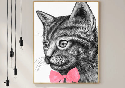 A framed black and white digital art print of a hand-drawn cat with a simple, modern design, hanging on a white wall.
