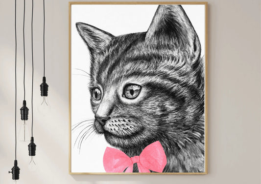 A framed black and white digital art print of a hand-drawn cat with a simple, modern design, hanging on a white wall.