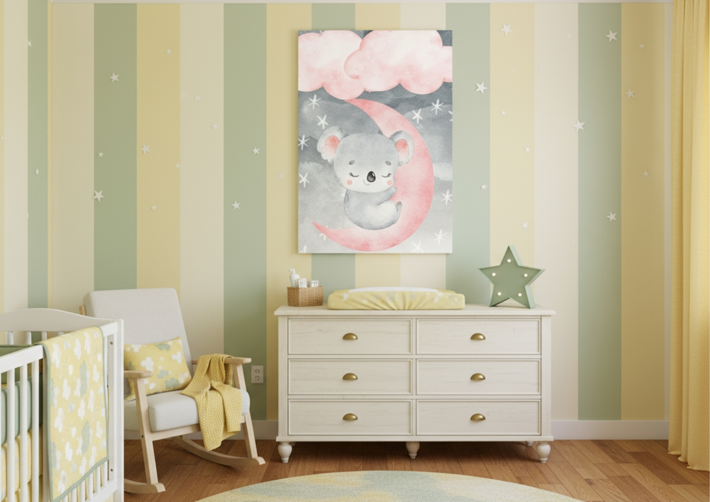 A cozy nursery room featuring walls decorated with alternating vertical stripes in soft yellow and sage green, patterned with small white stars. Hanging above a light wood changing table or dresser is a large canvas print of a watercolor sleeping koala nestled on a bright pink crescent moon, under pink and grey clouds. To the left, a white rocking chair with yellow accents and a white crib are visible. The wooden dresser is topped with a yellow changing mat and a green star-shaped light. The room uses a mix