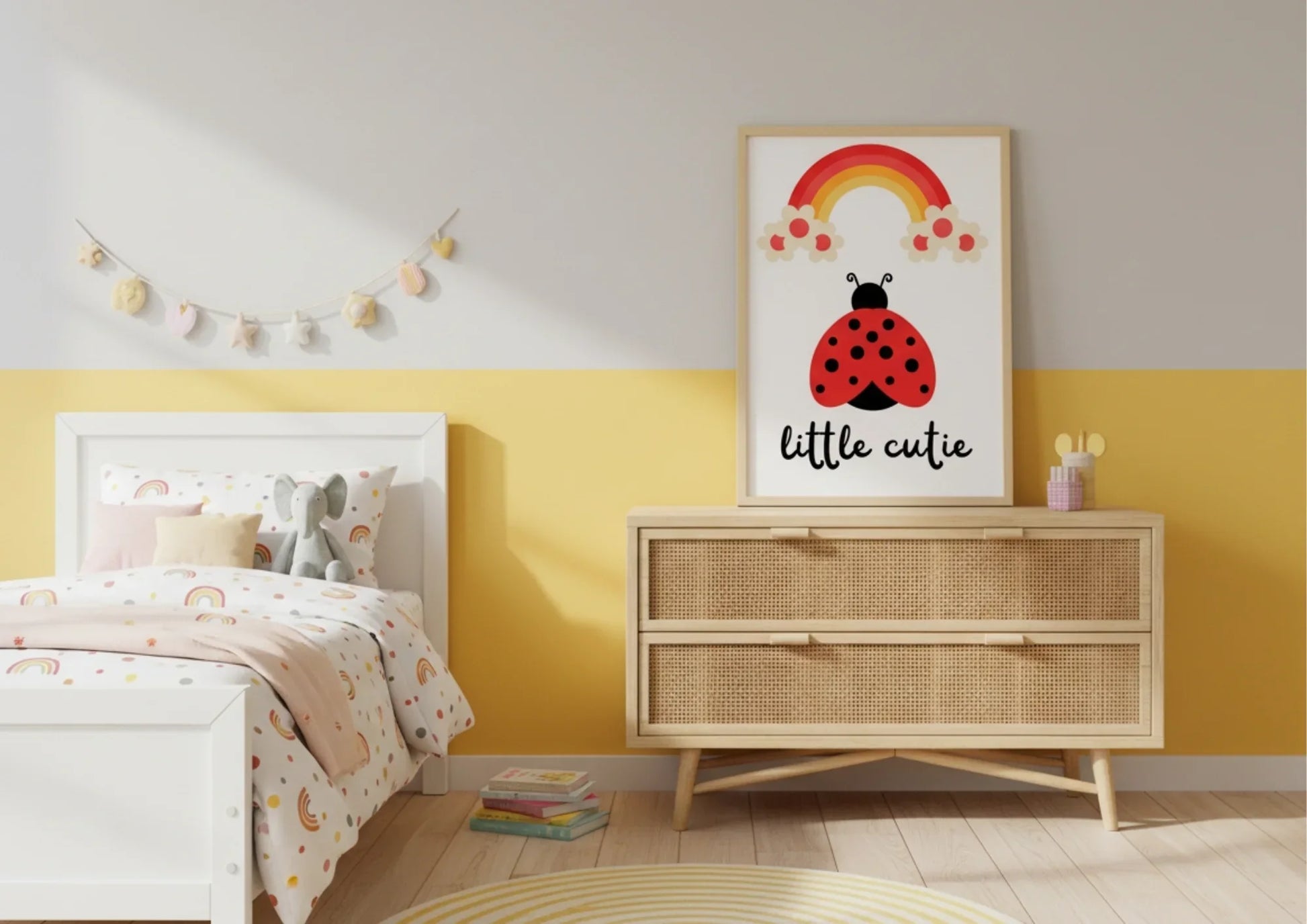 Children's bedroom with a dresser, bed, and wall art featuring a ladybug and rainbow.