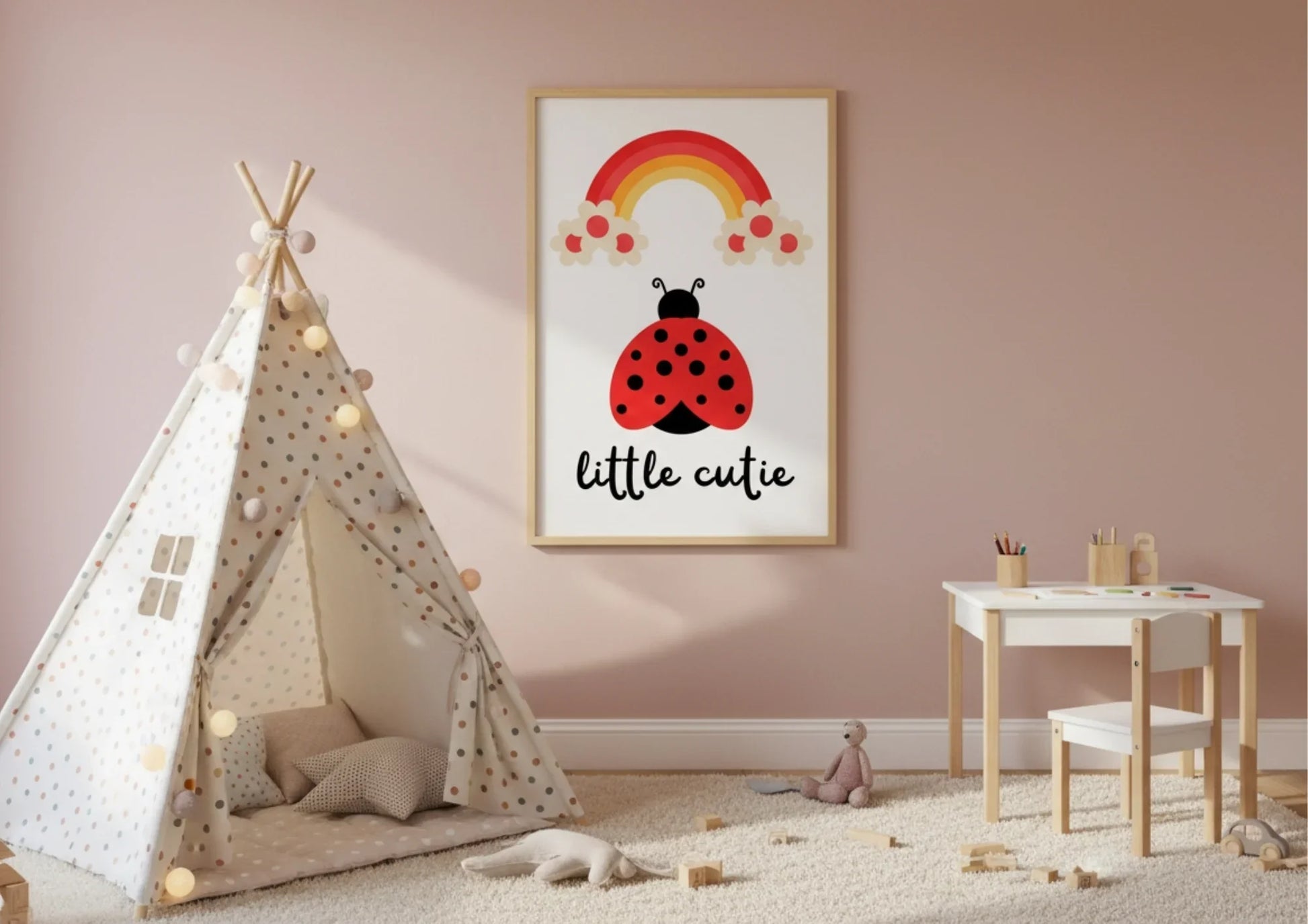 Children's room with a teepee, table, chair, and wall art featuring a ladybug and rainbow.