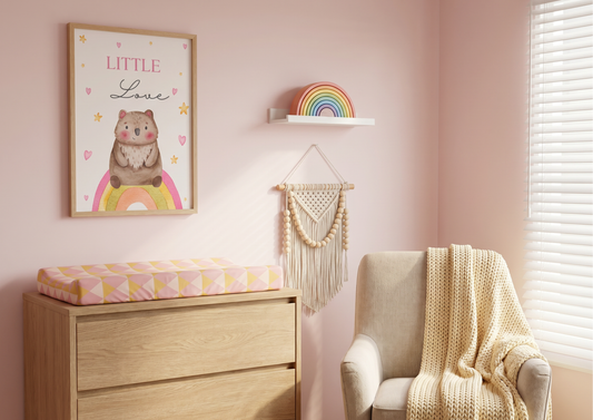 Nursery room with a dresser, chair, and wall decorations on a pink wall.