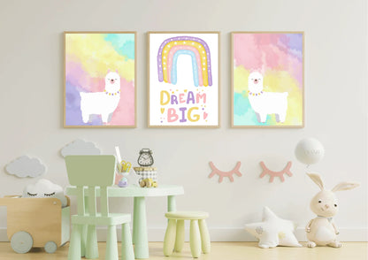 A set of three framed art prints with two llamas and a "Dream Big" quote on a white wall in a playroom with a mint green table and chair.