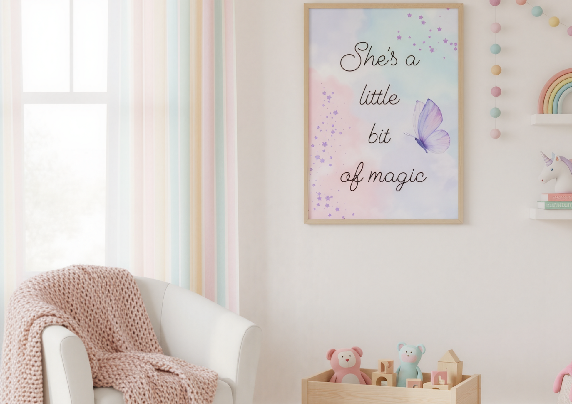 A sunny little girl's bedroom with a soft, pastel rainbow theme. The walls are a neutral color, and a framed art print with a watercolor background and the words "She's a little bit of magic" is hanging above a wooden toy box. The toy box is open and a few colorful toys are visible inside. The room is decorated with accents of soft, pastel rainbow colors, and a sunbeam is shining into the room from a nearby window.