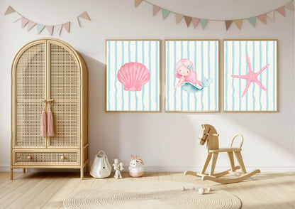 Children's room with a rattan armoire, rocking horse, and wall art featuring a mermaid and starfish.