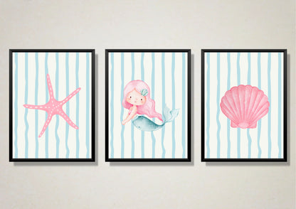 Three framed artworks featuring a mermaid, starfish, and shell on a striped background.