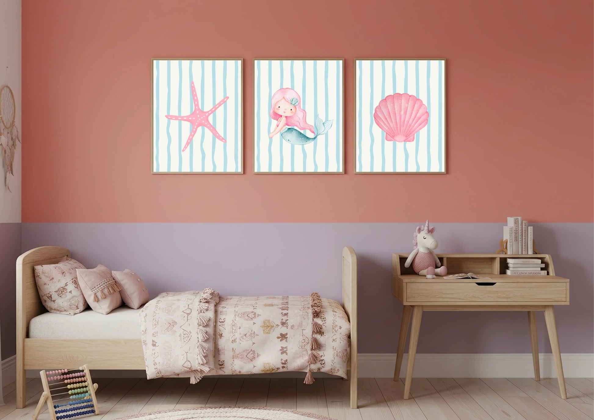 Children's room with a bed, desk, and wall art featuring a mermaid and sea-themed elements.