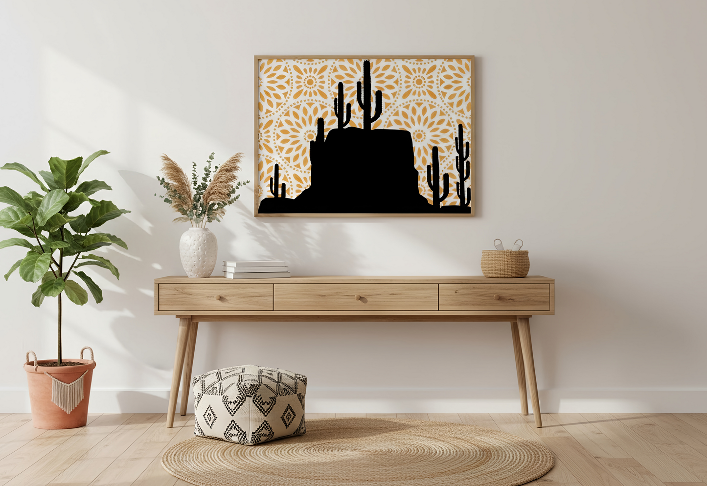 Wooden console table with decorative items against a white wall, featuring a framed artwork of cacti.