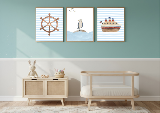 Three framed nautical-themed baby wall art prints hanging on a sage green and white nursery wall above a light wood crib and side cabinet.