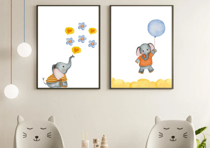 A close-up view of the two watercolor elephant prints hung on a light wall above two cat-eared chairs. The print on the left shows an elephant blowing blue flowers and hearts, and the print on the right shows an elephant flying with a blue balloon.