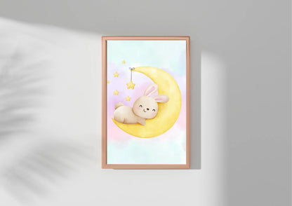 Framed artwork of a cartoon bunny on a moon with stars against a light gray background
