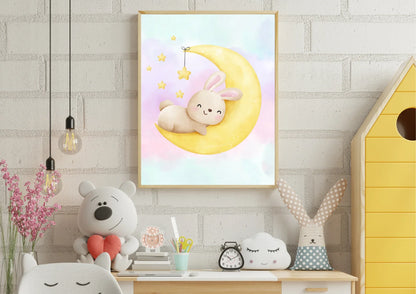 Children's room with a framed picture of a bunny on a moon, teddy bear, and decorative items.