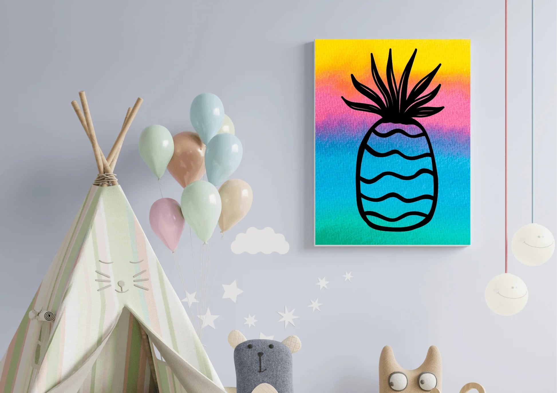Close-up of a colorful watercolor pineapple canvas print hanging on a light blue wall in a child's playroom, next to a striped teepee and a cluster of pastel balloons.