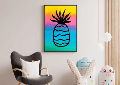 Framed watercolor pineapple print hanging on a pale wall in a nursery or playroom, positioned above a gray armchair and next to storage bins holding toys.
