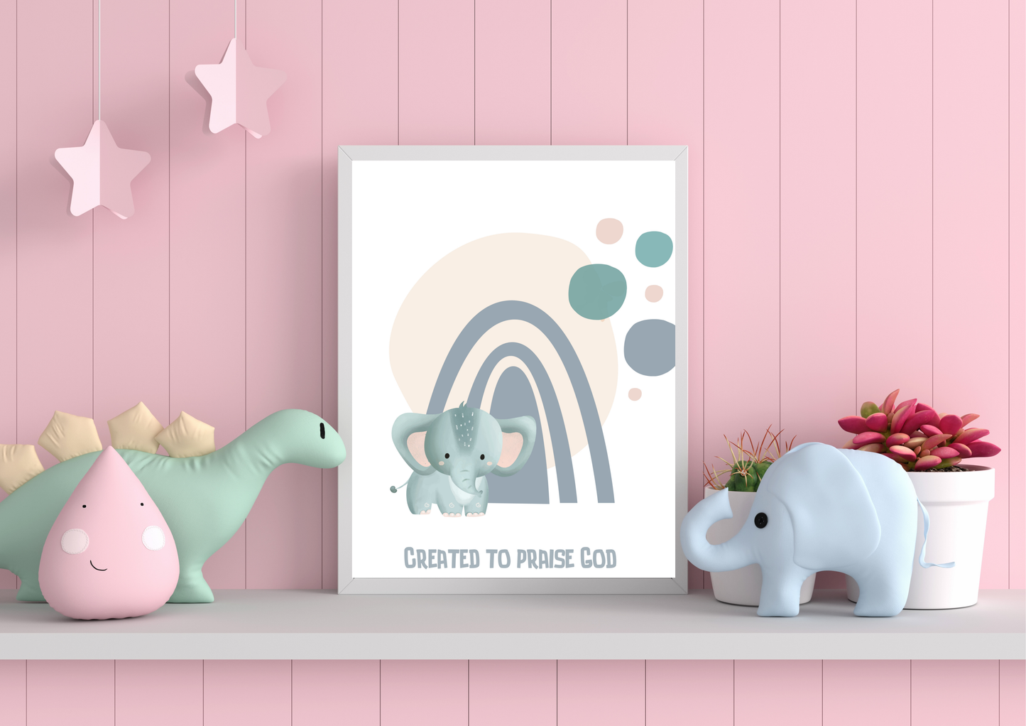 Framed children's poster with elephant and rainbow design on a pink wall with toys.