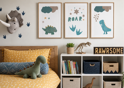 A styled children's bedroom corner featuring three framed dinosaur-themed wall art prints above a bed. The prints show a green dinosaur, blue footprint, and a blue T-Rex with the word 'ROAR' in the center.