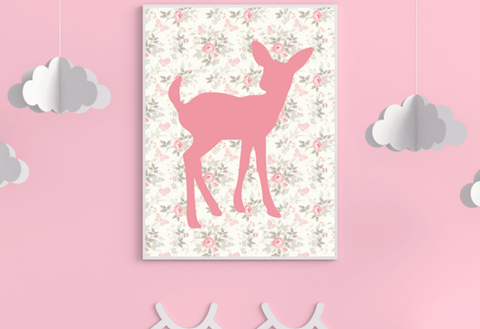 
A single framed art print featuring a pink deer silhouette on a background of small vintage-style flowers and butterflies. The print hangs on a light pink wall, with two white paper clouds hanging on either side.