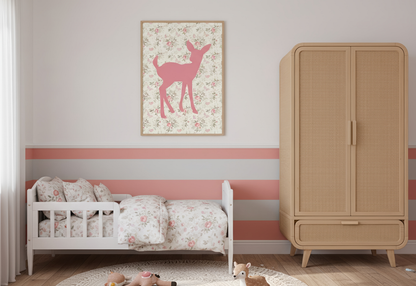 A whimsical toddler bedroom featuring a white toddler bed with pink floral bedding. A framed pink deer silhouette print on a vintage floral background hangs above a wall painted with horizontal stripes in white, salmon pink, and gray. A tall, light wood and cane webbing wardrobe stands on the right.