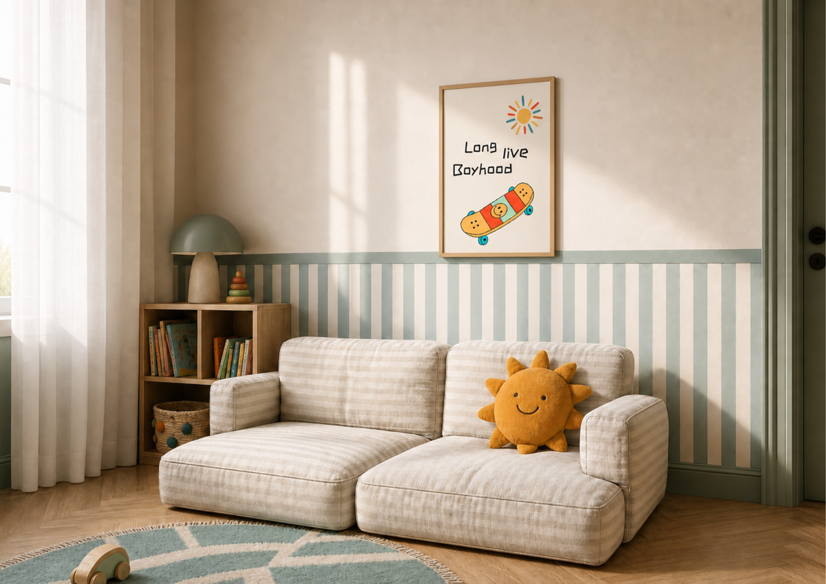 A cozy children's room scene featuring a cream and beige striped two-seater sofa with a yellow plush sun pillow. The background has a matching striped wall panel, a small wooden bookshelf, and a framed 'Long live Boyhood' poster on the wall.