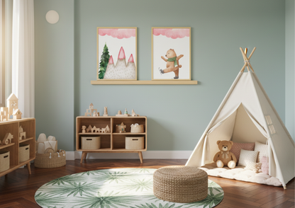Two framed winter bear watercolor art prints on a wooden ledge shelf in a light sage green children's playroom.