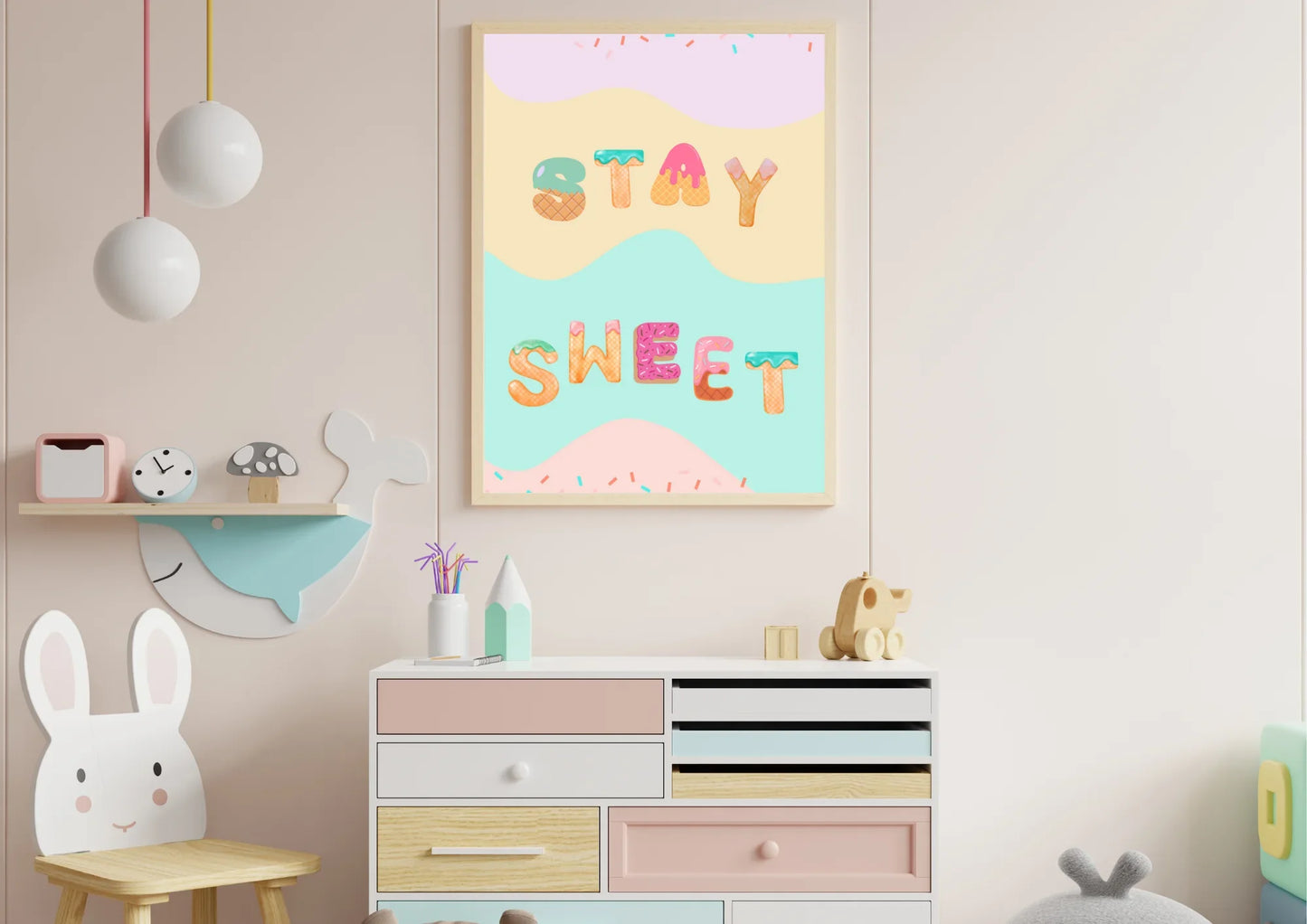 Children's room with colorful 'Stay Sweet' wall art and wooden furniture.