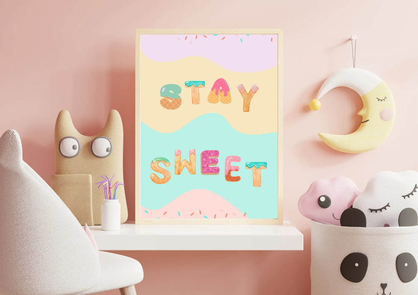 Children's room decor with a 'Stay Sweet' poster, plush toys, and a pink wall.