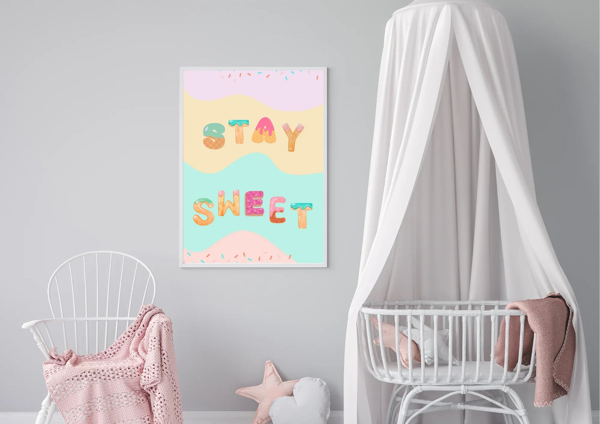 Children's room with a 'Stay Sweet' poster on the wall, white crib, and pink blanket.