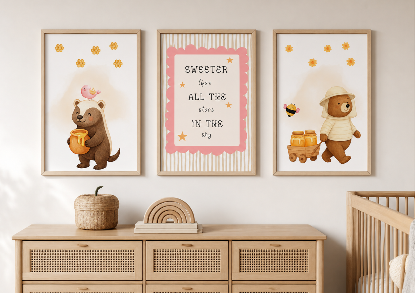 Nursery room with framed illustrations of bears and text on a wall above a wooden dresser.
