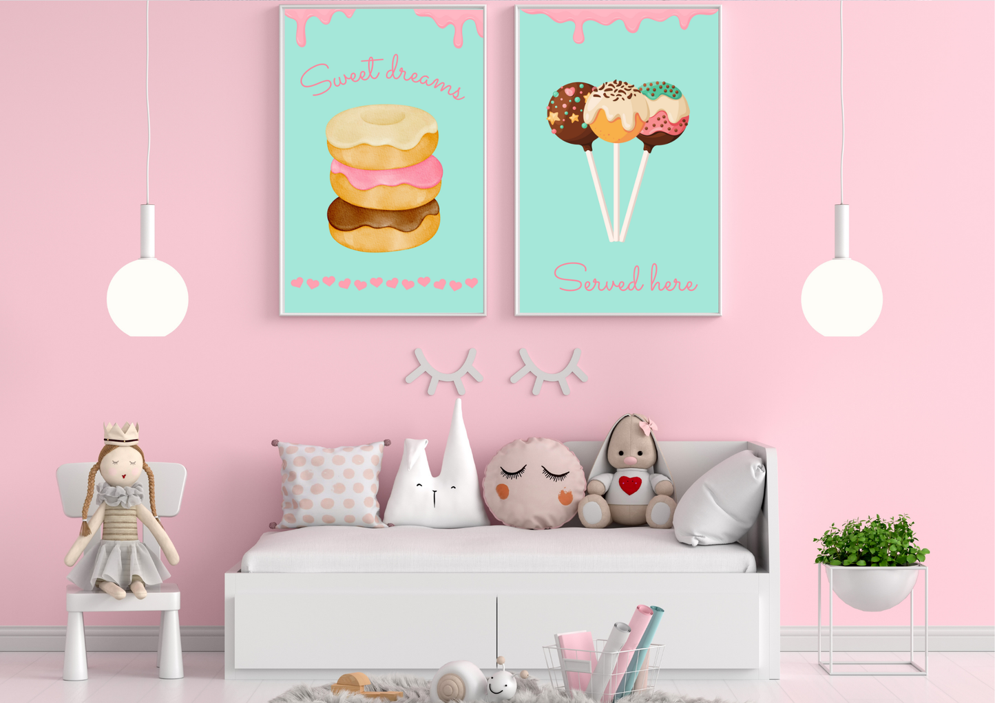 A set of two framed art prints of donuts and cake pops on a pink wall above a daybed in a child's room.