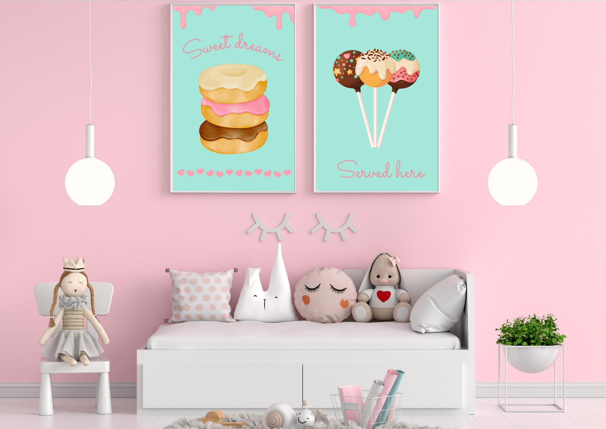A set of two framed art prints of donuts and cake pops on a pink wall above a daybed in a child's room.