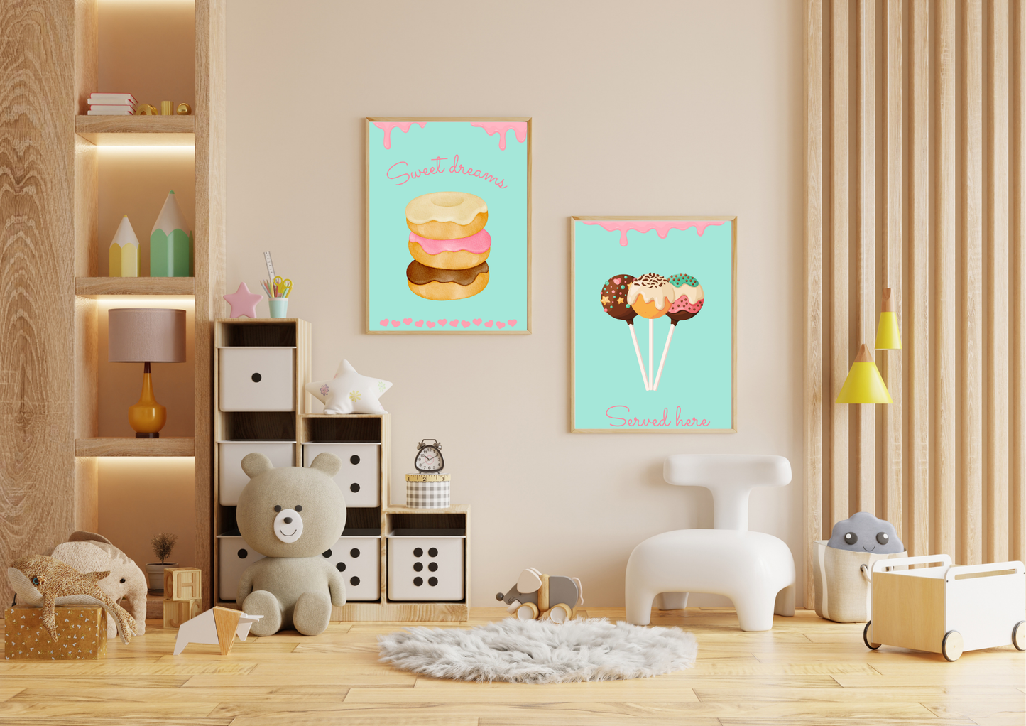 A set of two framed art prints of donuts and cake pops on a beige wall in a child's playroom with a bookshelf and a teddy bear.