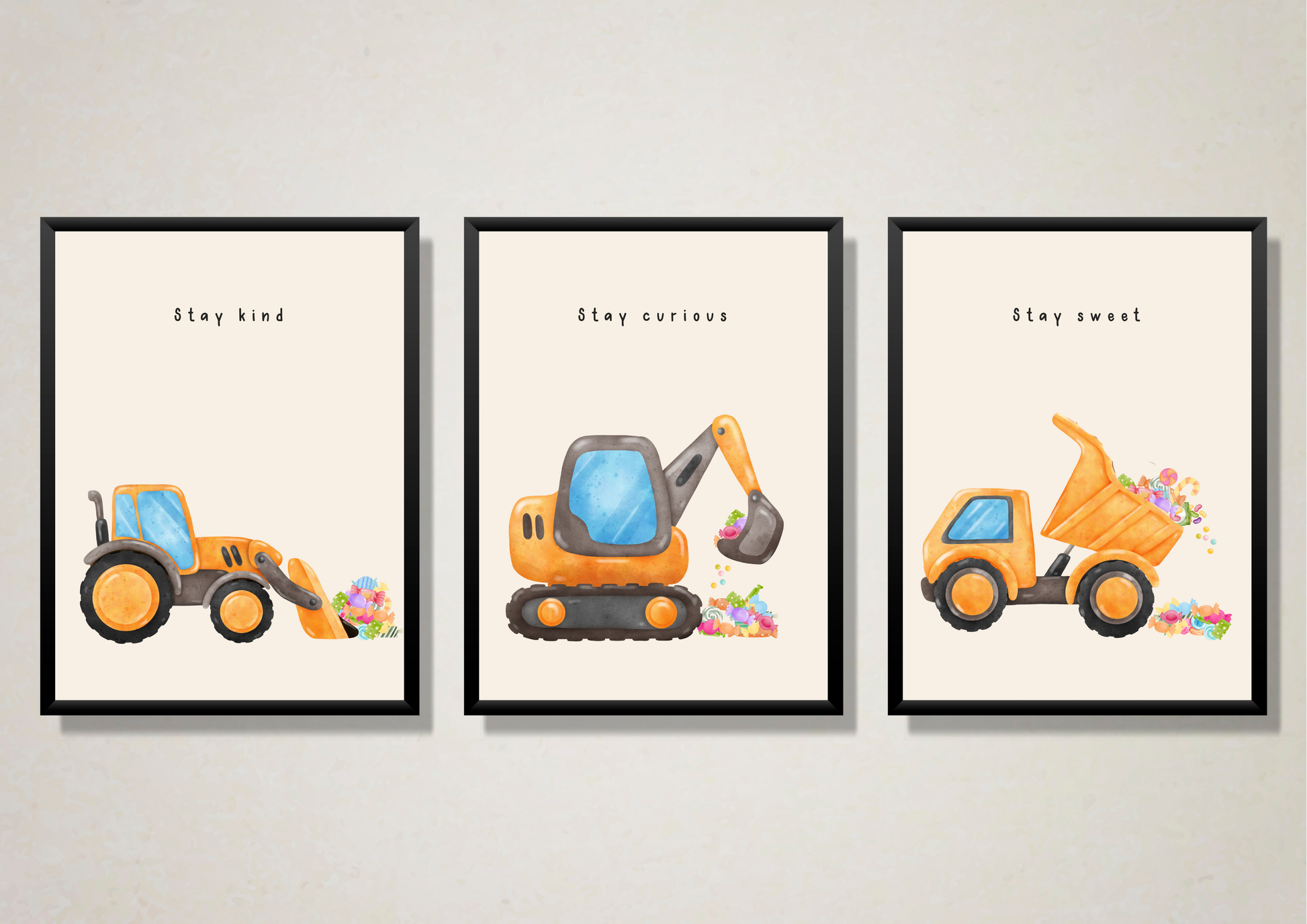 Close-up view of the set of three construction vehicle prints (Stay Kind loader, Stay Curious excavator, Stay Sweet dump truck with candy) in modern black frames.