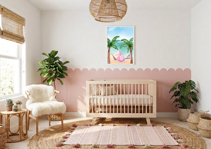 Watercolor flamingo nursery wall art featuring a pink flamingo resting in a tropical hammock between palm trees, framed on a white wall above dusty pink scalloped wainscoting. Coastal-themed baby room with a light wood crib, a fluffy white faux fur chair, and woven bamboo window blinds. Modern boho nursery decor with large indoor plants, a rattan side table, and a pink tasseled rug layered over a round jute rug.