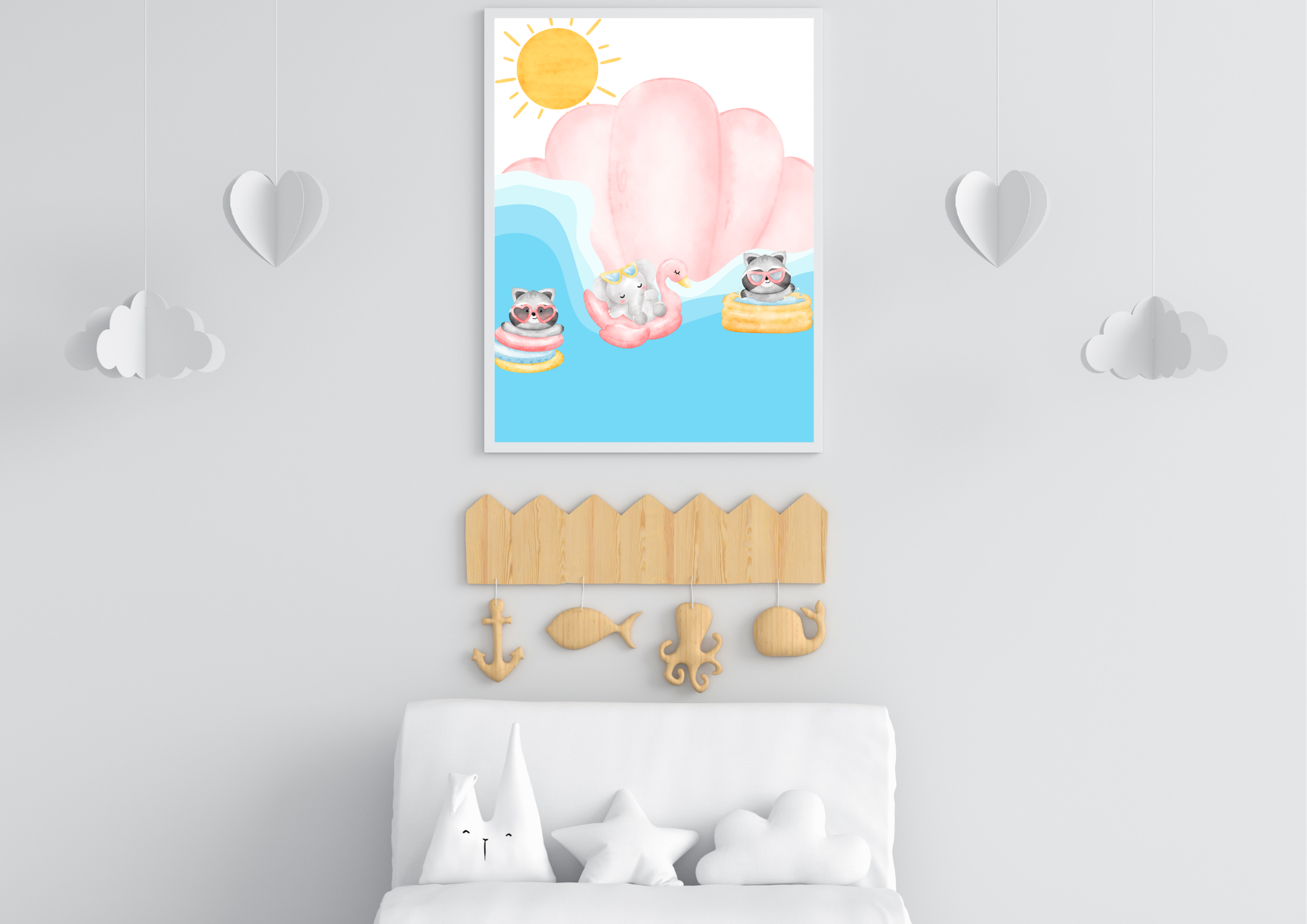Watercolor print featuring ocean animals in pool floats under the sun, hanging above a white crib with cloud and star pillows, decorated with wooden nautical hooks.