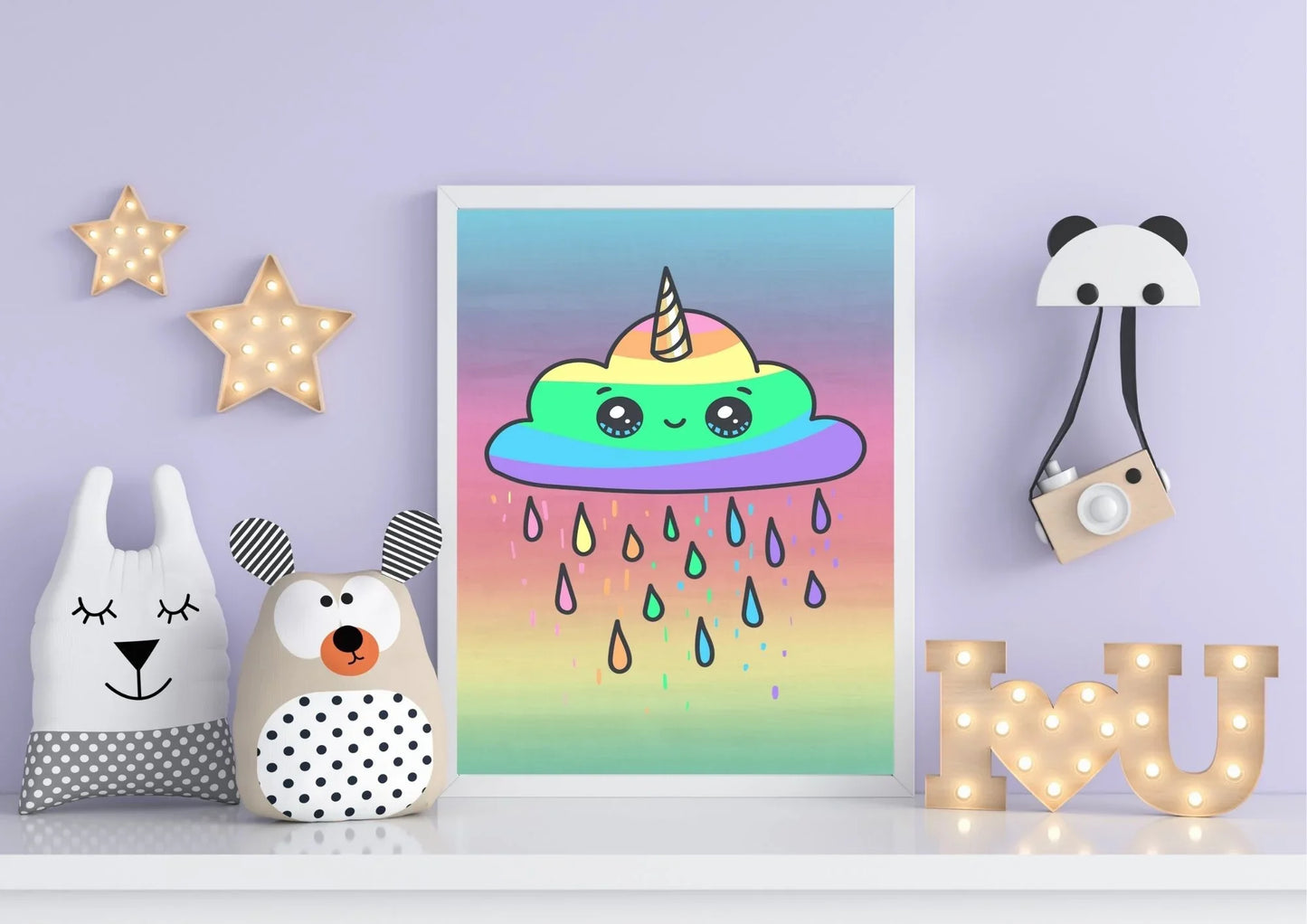 Colorful rainbow cloud with a unicorn horn framed on a wall with decorative items.