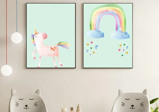 A set of two framed digital nursery art prints featuring a watercolor unicorn and a rainbow with hearts and clouds on a mint green background.