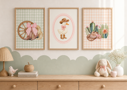 Three framed artworks on a wall above a wooden shelf with decorative items.