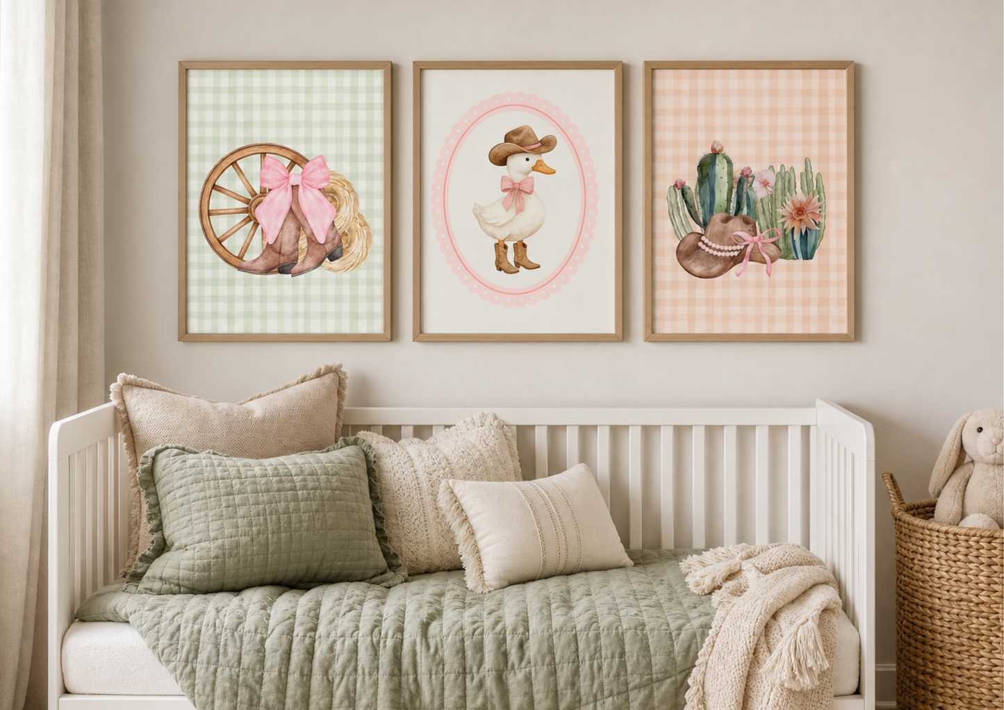 Nursery room with a crib, decorative pillows, and western girl's wall art featuring a watercolor duck, cactus, and wheel.
