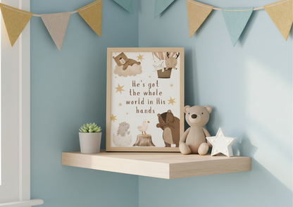 Nursery shelf with framed artwork, teddy bear, and decorative items against a light blue wall with a bunting.