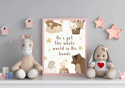 Decorative shelf with stuffed animals and a framed religious nursery quote on a gray wall.