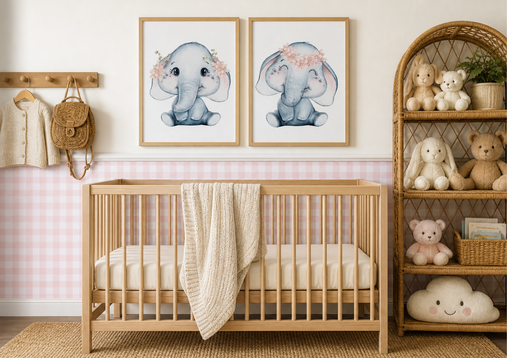 A styled nursery scene featuring two framed watercolor elephant prints hanging above a light wood crib. The room has a pink-and-white gingham wall, a woven basket shelf with stuffed toys, and a beige rug on the floor.